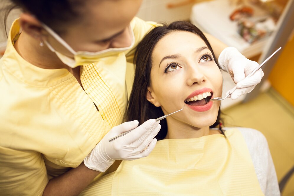 Dentist with patient at clinic